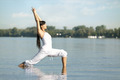 Outdoor Portrait of Beautiful Young Woman Doing Yoga in Water Outdoor Portrait of Beautiful Young Woman Doing Yoga in Water - PhotoDune Item for Sale