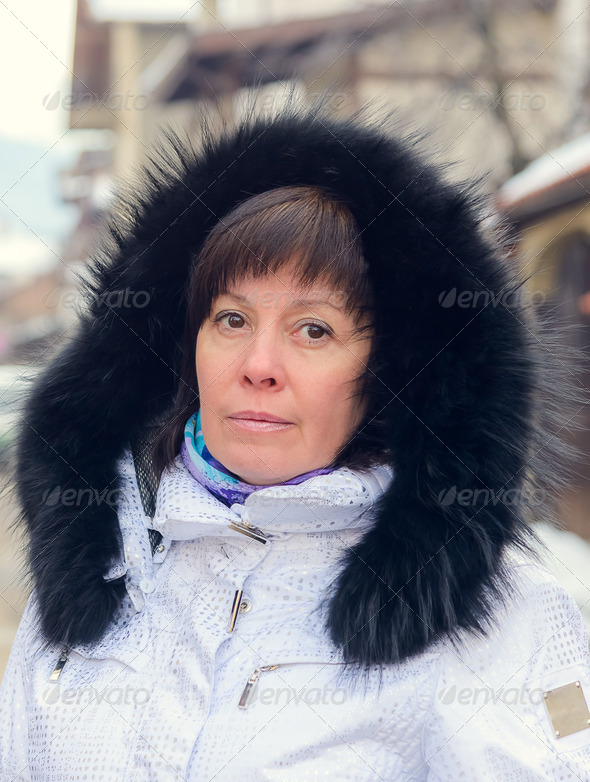 Brunette middle-aged woman in a stylish white jacket with fur ho (Misc) Photo Download