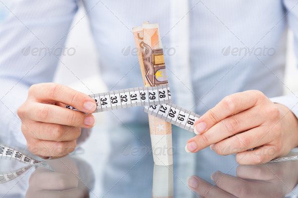 Businessperson With Measuring Tape And Banknote (Misc) Photo Download