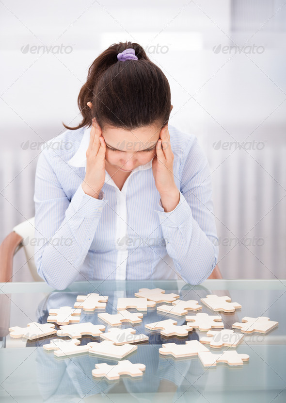 Businesswoman With Puzzle At Desk (Misc) Photo Download