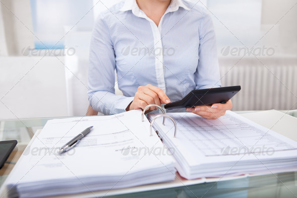 Businessperson Checking An Invoice In Office (Misc) Photo Download