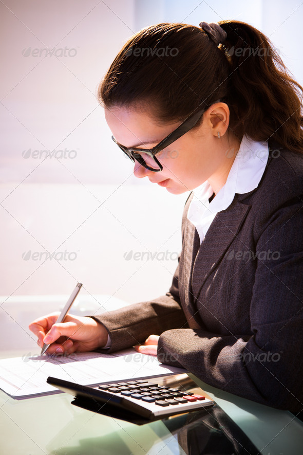 Businesswoman Calculating Tax (Misc) Photo Download