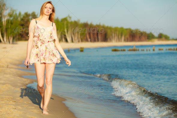 Summer vacation. Girl walking alone on the beach. (Misc) Photo Download